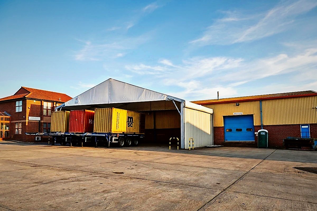 The yard at our UK depot, container trailers lined up beside the warehouse
