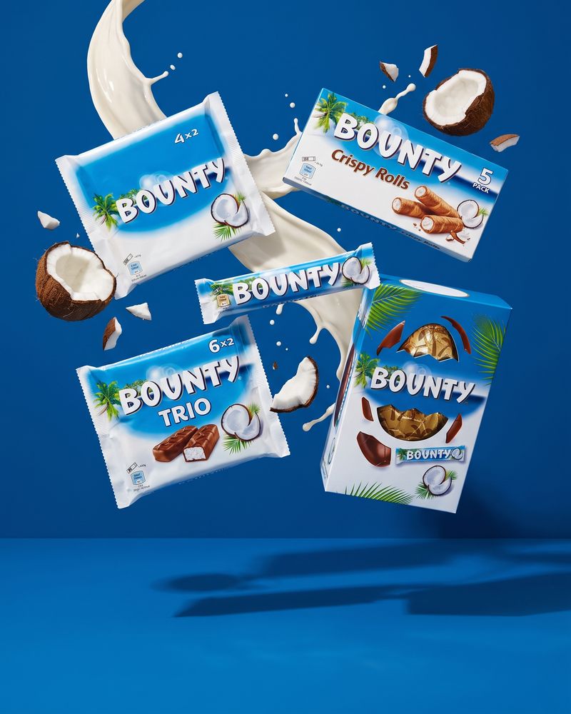 Bounty twin bars and multipacks arranged on a dark blue surface