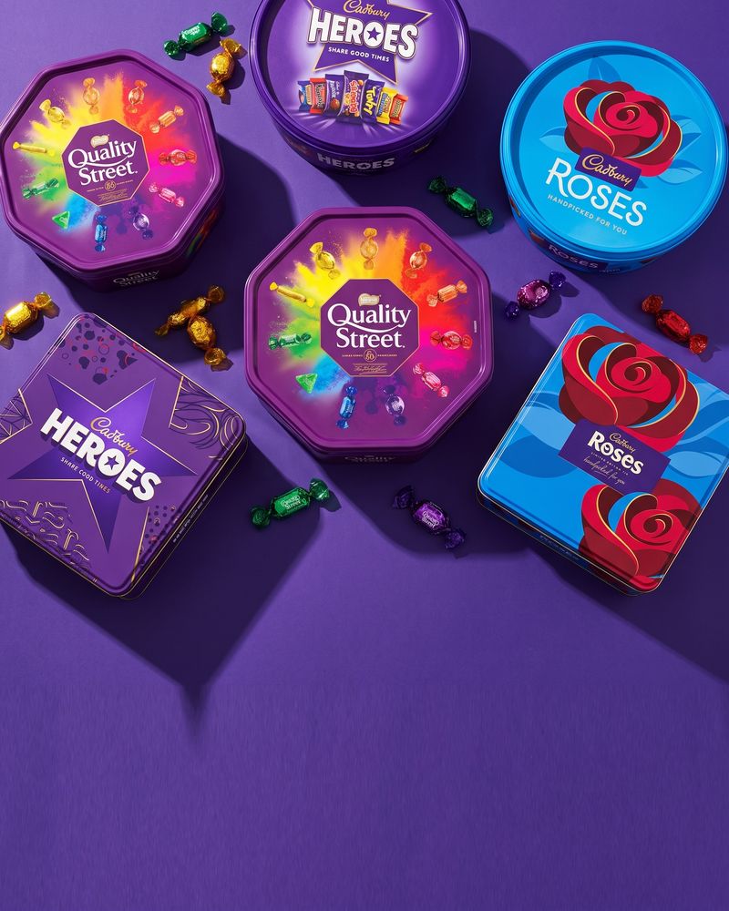Cadbury Heroes, Roses and Quality Street tubs and tins grouped together
