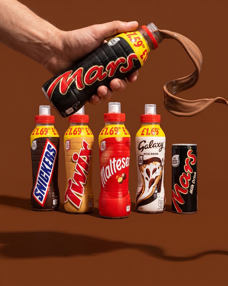 Mars, Snickers and Galaxy milk drink bottles standing in a row